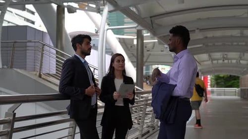 Business Team Meeting on Modern City Walkway