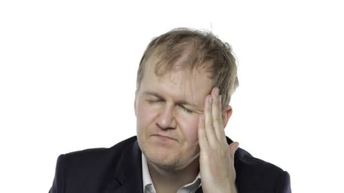 Man Experiencing Headache and Massaging Temples