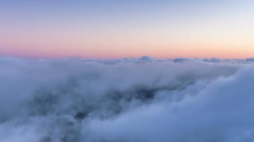 Aerial View Over Soft Clouds at Sunrise