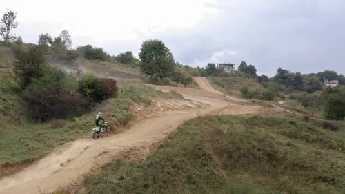 Racer On Sports Motorcycle Rides At High Speed On Dirt Road