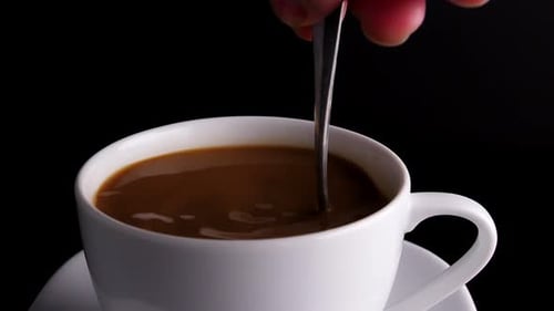 Close Up of Coffee Being Stirred with Spoon