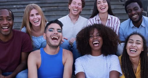 Diverse Group Smiling and Laughing on Stairs