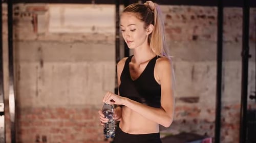 Exhausted Female Athlete Taking Break In Gym