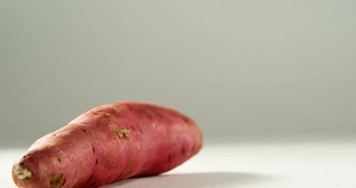Studio Shot of a Red Yam on White Surface