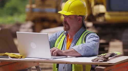 Construction worker using laptop computer