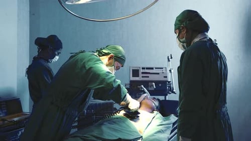 Surgical doctor team performing surgery patient on operating room in hospital