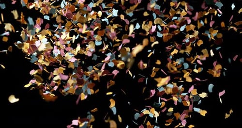 Confettis Falling against Black Background, Slow Motion 4K