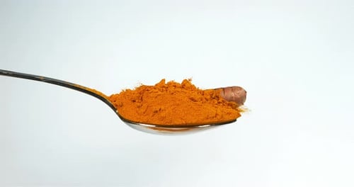 Turmeric, curcuma longa, Root falling on curcuma Powder, Indian Spice, Slow Motion 4K