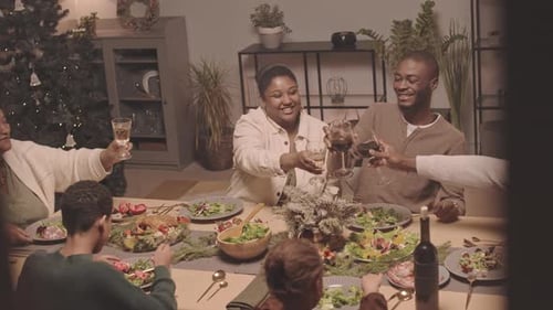 Family Celebrates Christmas Together at Dinner Table