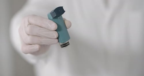Close up of Hand Holding an Asthma Inhaler