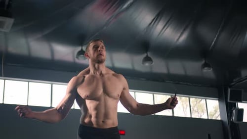 Young male athlete exercising cardio with jump rope, cardio and endurance training