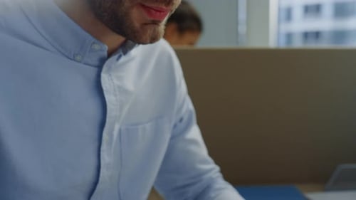 Man Types on Laptop Analyzing Data in Office
