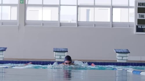 Swimmer swimming into the pool