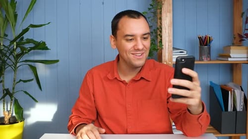 Man Video Calling with Smartphone Indoors