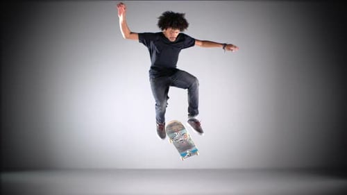 Skateboarder Performing Aerial Trick in Studio