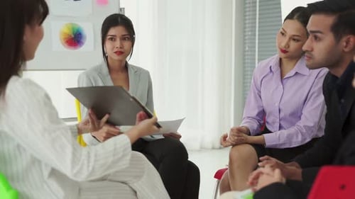 Business People Proficiently Discuss Work Project While Sitting in Circle