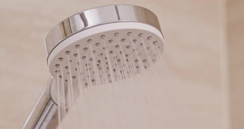 Close up of Shower Head with Running Water