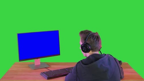 Professioneller Spieler, der seinen PC auf einem Greenscreen betrachtet, Chroma Key