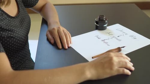 Close Up Shot of a Young Woman Calligraphy Writing on a Paper Using Lettering Technique