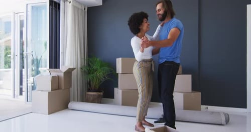 Happy Couple Dancing in New Home on Moving Day