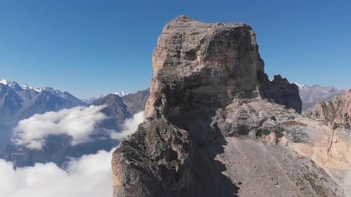 Aerial Shot of Flying Over the Mountain Peaks Among the Clouds