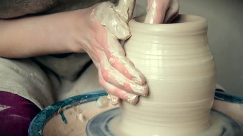Hands Shaping Clay on Pottery Wheel
