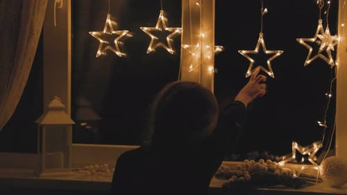 Festive Holiday Window Decorations at Night