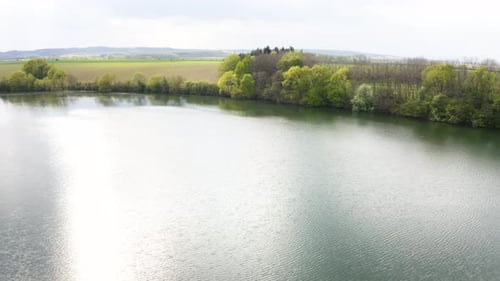 Aerial Drone Shot a Large River in a Rural Area on a Sunny Day Drone Flies Backward