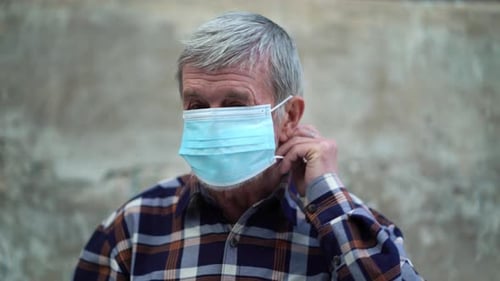 Senior Man Wearing Protective Medical Face Mask