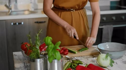 Woman Preparing Fresh Vegetables in Bright Kitchen
