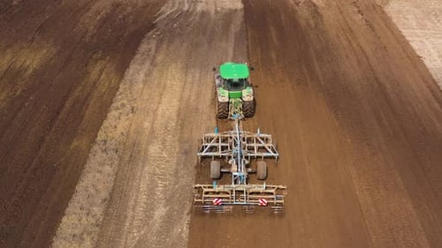 The Tractor Plows the Field Prepares for Crops