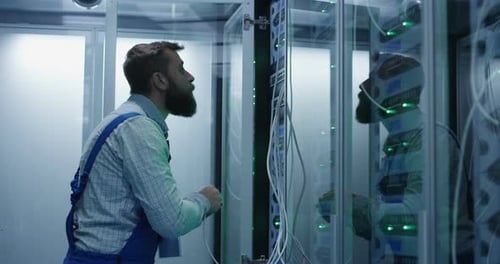 Male Technician Working in a Data Center