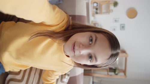 Smiling Girl Talks to Camera Indoors