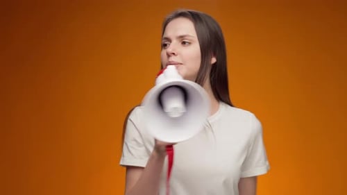 Young Adult Speaking Into A Megaphone