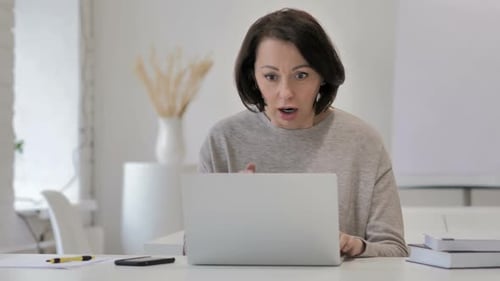 Woman Reacts in Shock to Laptop Screen