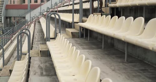 Young Adult Exercising on Bleachers in Stadium