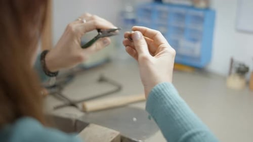 Jeweler Working on Jewelry Design with Pliers