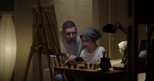 Father and Son Painting Together
