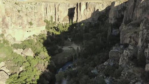 Aerial Deep Long Rift Canyon with Cleft Steep Rock Walls and High Cliff Gorge