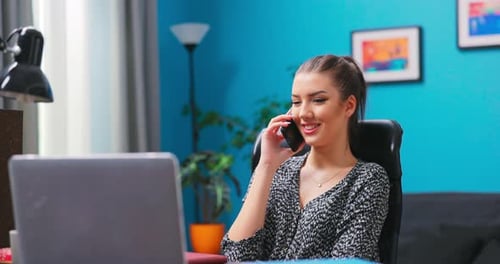 Woman Talking on Phone in Home Office