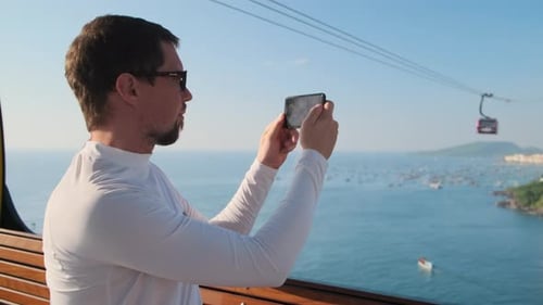 Travel in Vietnam Trendy Resort Phu Quoc Man in Cabin of Longest Cable Car