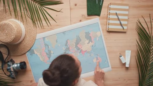 Woman Planning Travel Destinations With Map