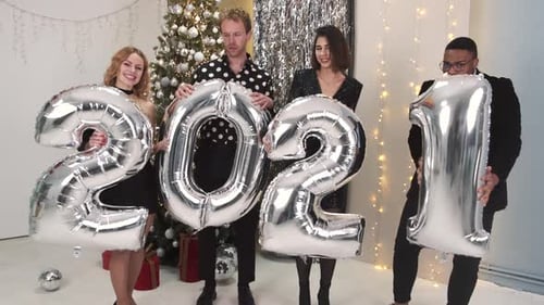 Friends Celebrate New Year's Eve Holding 2021 Balloons