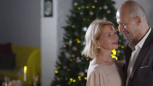 Middle-Aged Caucasian Couple Dancing at Christmas Party