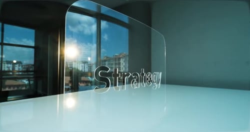 Glass Strategy Letters and Office in Background