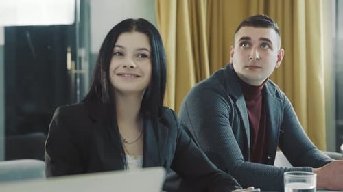 Office Workers Look at the TV Screen and Watch Closely