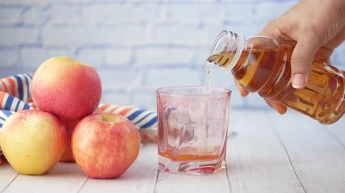 Pouring apple juice into a glass