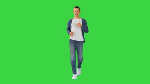 Young White Man Runs Smiling on a Green Screen Chroma Key