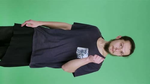 Portrait of a Man with Dark Hair and a Beard on a Green Screen