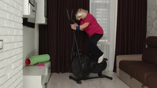 Senior Woman Exercising on Elliptical at Home